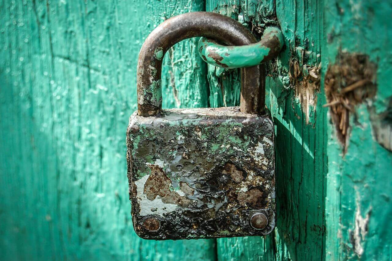 Rusty Padlock On Blue Door